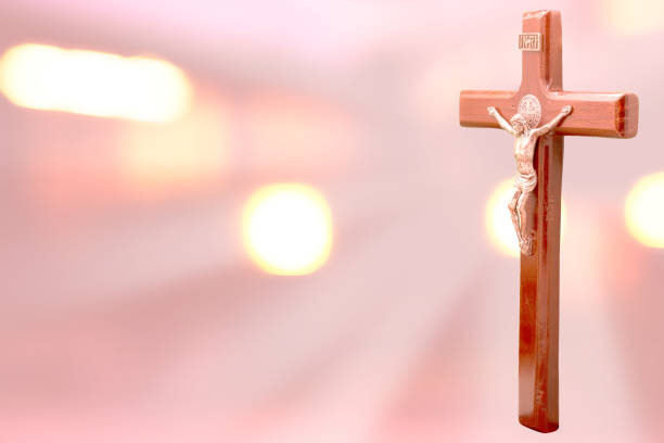istock jesus on the cross on pink bokeh  background 1143474265