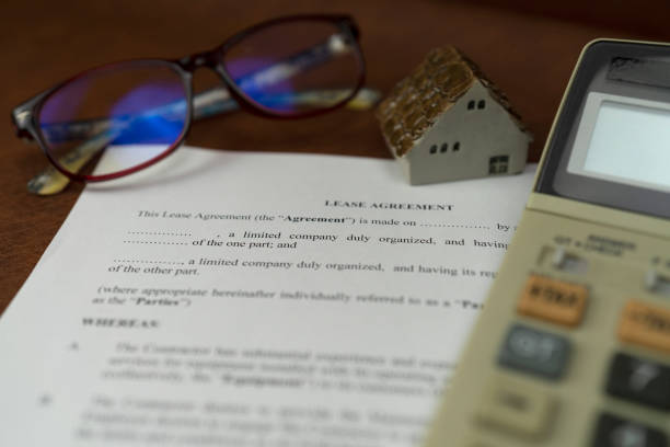 istock Selective focus of lease agreement with calculate and glass 1143474432