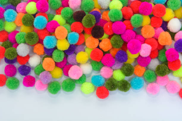 istock A colorful  Pom Pom background with white space 1143478197