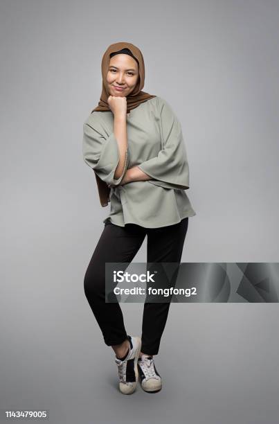 Muslim Girl Posing And Smiling In Front Of Camera Isolated On Grey Background Stock Photo - Download Image Now