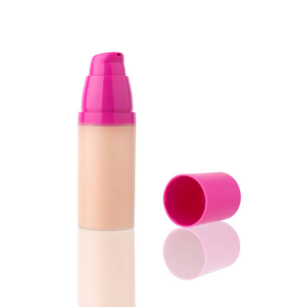 istock Face foundation beige cream in glass bottle with open plastic pink cap on white background with reflection isolated close up, eye concealer dispenser package mockup, skin corrector or toned base jar 1143479834