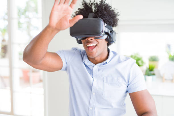 istock African American man having fun playing with virtual reality glasses 1143480463