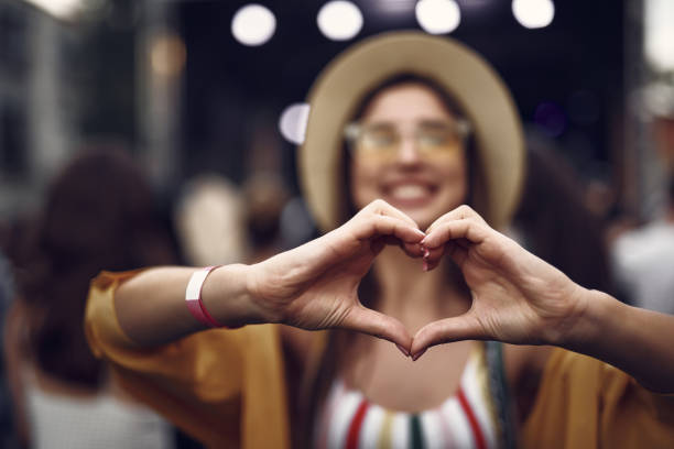 istock Cheerful girl making heart sign with two hands 1143480595