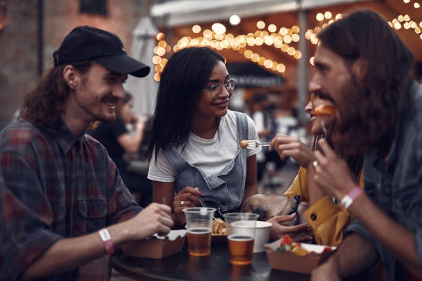 istock Hipster friends chatting while having lunch at outdoor cafe 1143480679