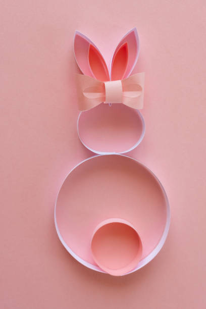 istock Cute paper bunny with bow on pink background 1143480738