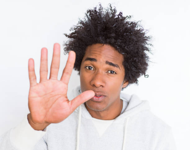 istock African American man over white isolated background with open hand doing stop sign with serious and confident expression, defense gesture 1143480744
