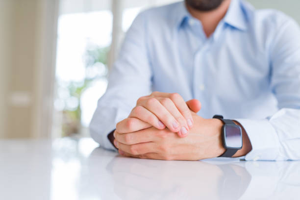istock Close up of man crossed hands over white table 1143482197