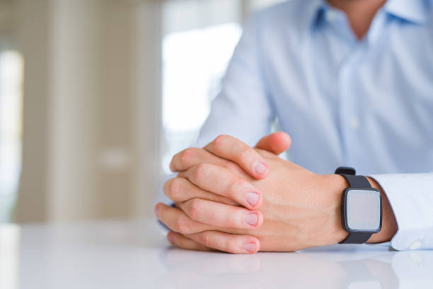 istock Close up of man crossed hands over white table 1143482210