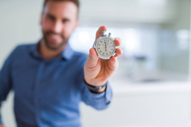 istock Handsome man showing stopwatch 1143482290