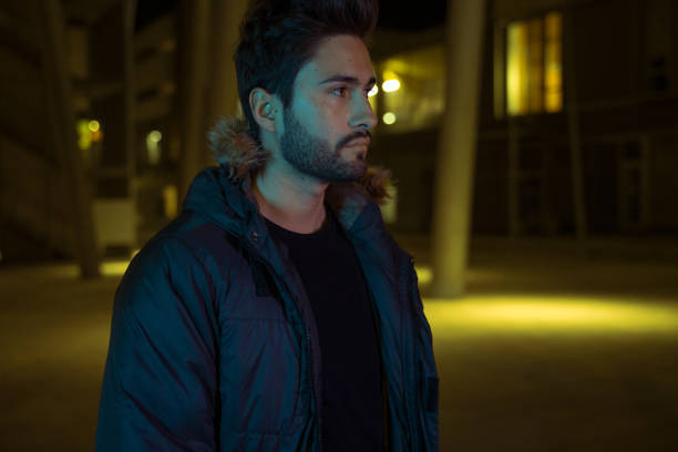 istock Young man walking in the city at night 1143482618
