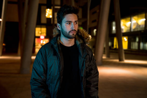 istock Young man walking in the city at night 1143482691