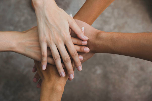 istock Close up top view hands teamwork in cooperation of business. 1143483847