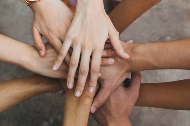 istock Close up top view hands teamwork in cooperation of business. 1143483891