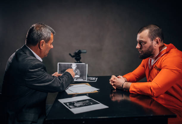 istock Prisoner and detective in the investigation room 1143484672