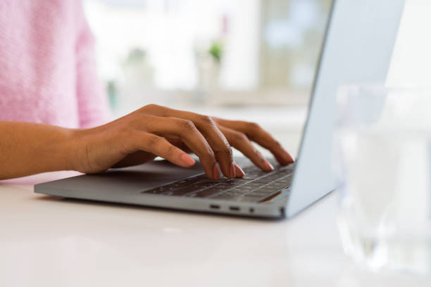 istock Close up of young woman working typing using laptop 1143484960