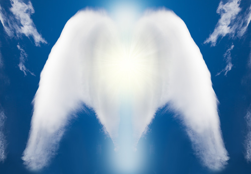 Beautiful abstract shape of an angel created by clouds on blue sky
