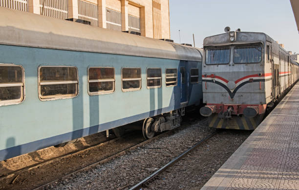 istock Railway locomotive and carriages at a station platform 1143486529