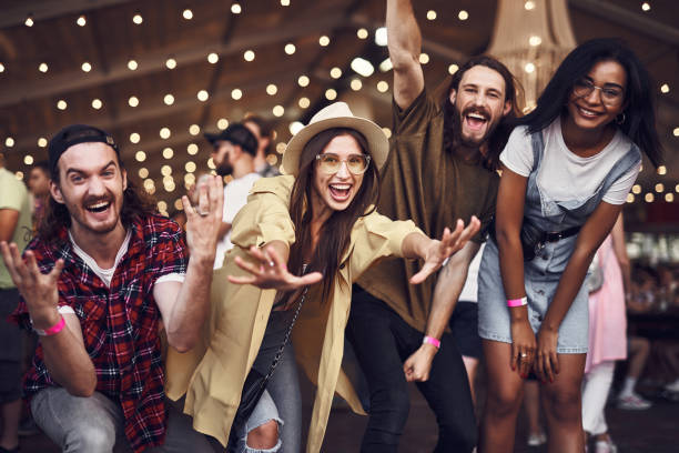 istock Expressive people laughing and putting hands up while looking happy 1143487133