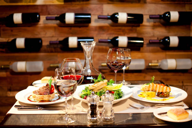 romantic dinner with food and vine setting - restaurant wine table table for two imagens e fotografias de stock