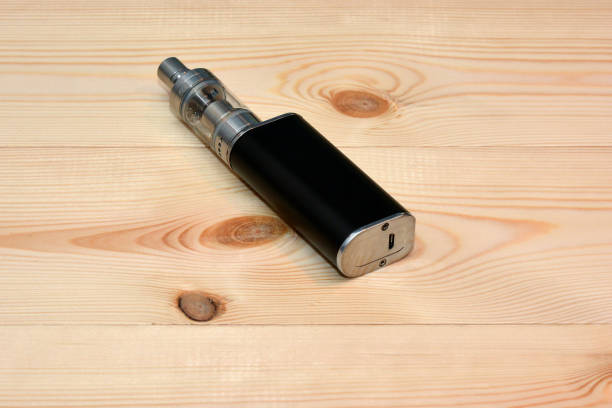 istock E - cigarette for vaping , technical devices.The liquid in the bottle 1143489898