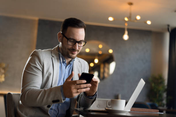 istock Businessman using mobile phone in cafe 1143491932