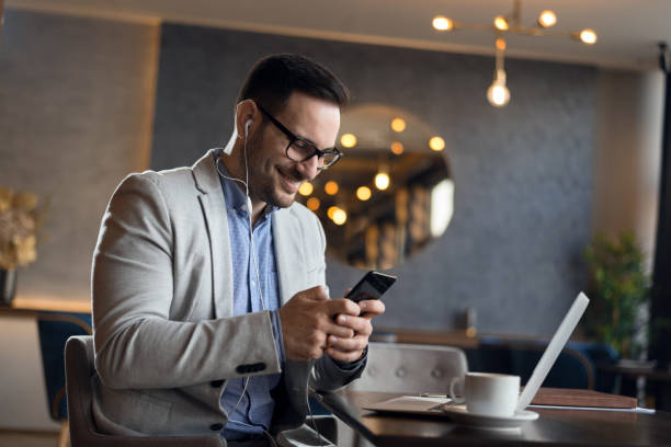 istock Businessman using mobile phone in cafe 1143491961