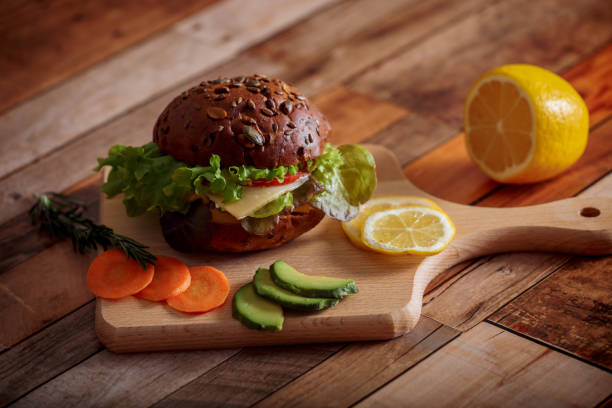 istock Dark burger with salad, rosemary and lemon 1143492670