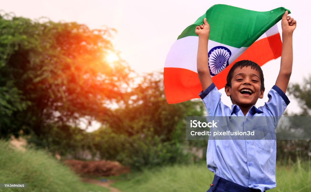 Cheerful elementary age child portrait with Indian national flag Cheerful elementary age child portrait with Indian national flag. India Stock Photo