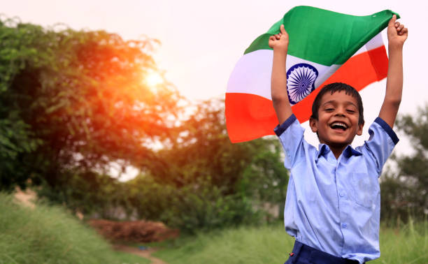 Cheerful elementary age child portrait with Indian national flag stock photo