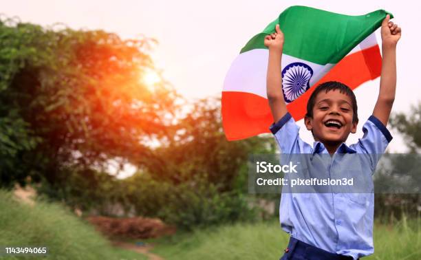 Cheerful Elementary Age Child Portrait With Indian National Flag Stock Photo - Download Image Now