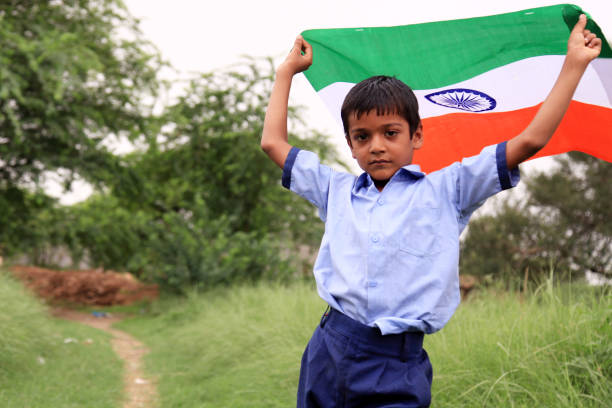 istock Cheerful elementary age child portrait with Indian national flag 1143494087
