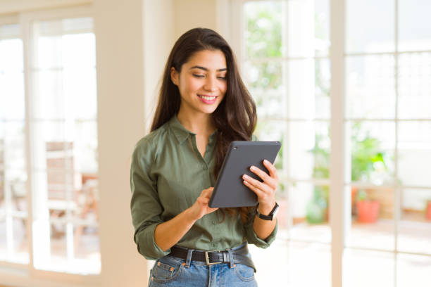istock Beautiful young woman working using touchpad tablet 1143494215