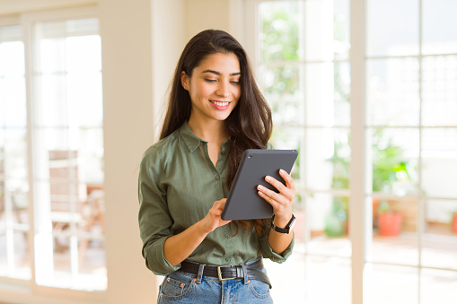 Beautiful young woman working using touchpad tablet