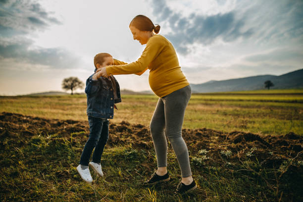 istock Pregnant mother playing with son 1143494262