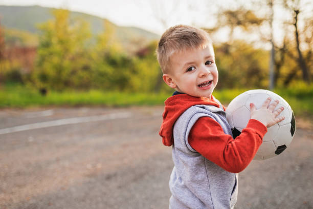 istock Little Boy Playing Soccer 1143494897