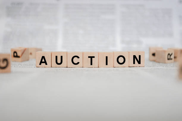 istock Auction Word Written In Wooden Cube - Newspaper 1143495527