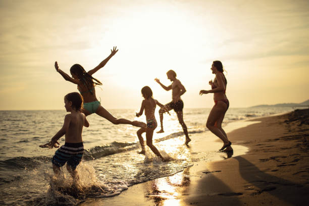 istock Family with three kids enjoying vacation on beach 1143495814