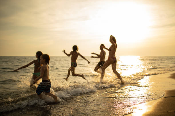 istock Family with three kids enjoying vacation on beach 1143495889
