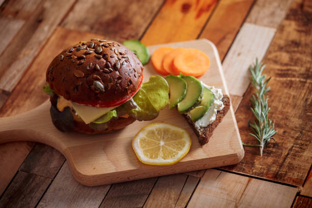 istock Dark burger with salad, rosemary and lemon 1143497387