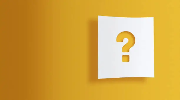 Photo of question mark on white information paper on yellow background