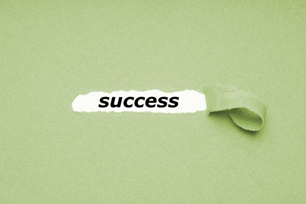 istock finding success concept - hole in paper background revealing hidden text 1143498022