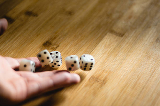 istock Rolling dices on a wooden table for gambling 1143498028