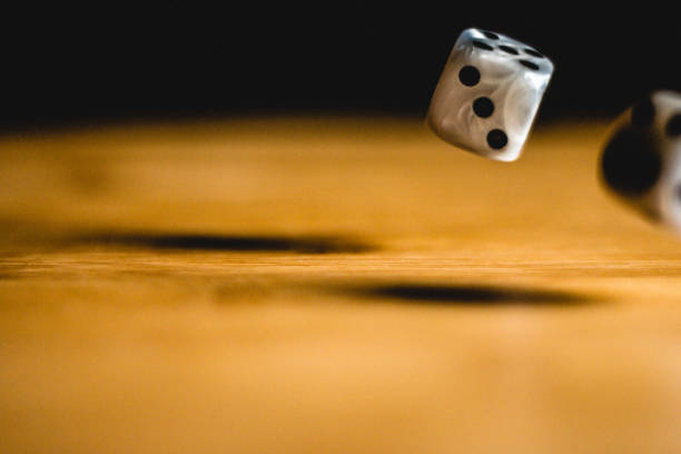 istock Rolling dices on a wooden table for gambling 1143498038