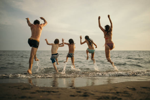 istock Family with three kids enjoying vacation on beach 1143499533