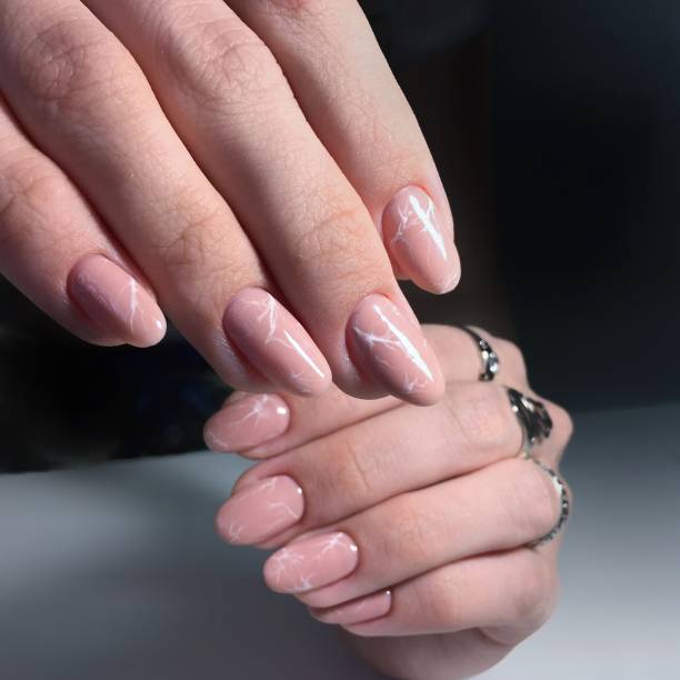 istock professional pink female manicure on nails close up 1143500579