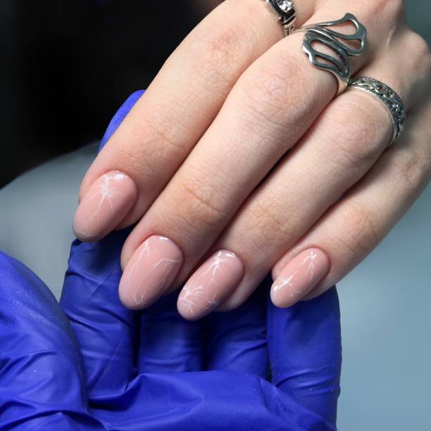 istock professional pink female manicure on nails close up 1143500581