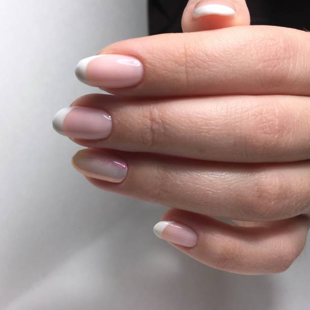 istock professional pink female manicure on nails close up 1143500621