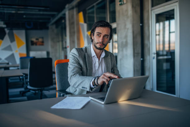 istock Charming businessman sitting in office 1143500663