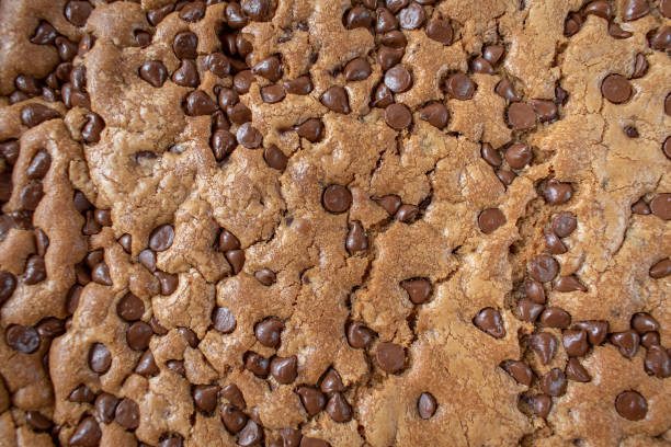 istock closeup of large chocolate chip cookie cake on rustic white background 1143501107