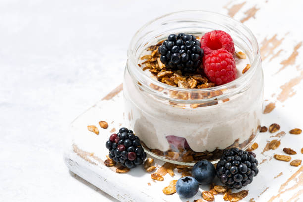 istock healthy creamy dessert with fresh berries in jar 1143501200